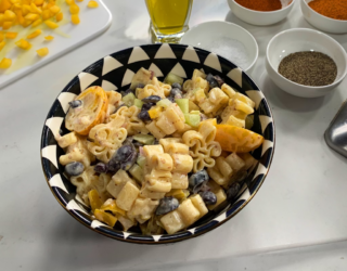 a close up of a dish of black and gold pasta salad