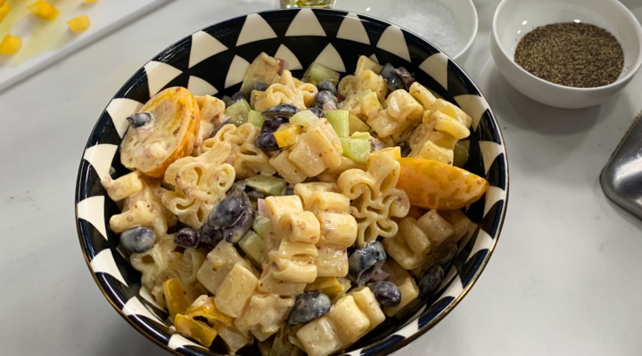 a close up of a dish of black and gold pasta salad