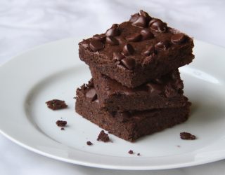 a close up of a plate with 3 black bean bownies