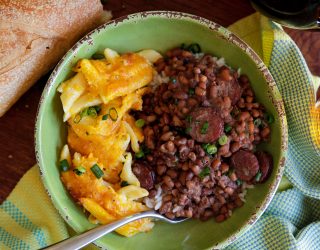 a bowl of Patricia’s Perfect Field Peas with sasuage and a type of penne pasta and cheese