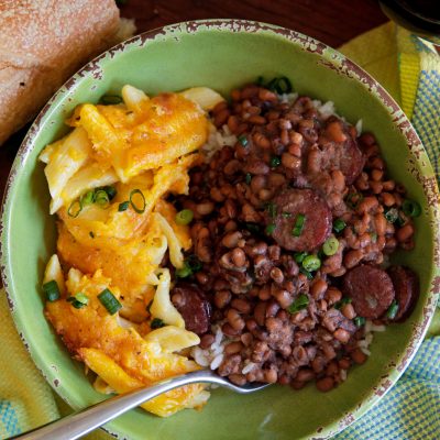 a bowl of Patricia’s Perfect Field Peas with sasuage and a type of penne pasta and cheese