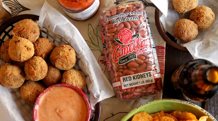 a tray of red beans and rice boudin balls with dipping sauce in a cup on the side, next to a package of camellia brand red kidneys