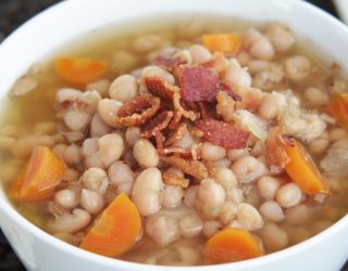 a close up of a bowl of navy bean bacon chowder