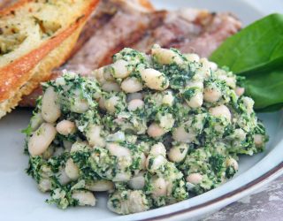 a close up of a plate of white bean spinach puree