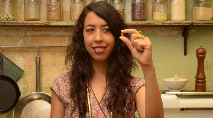 a woman holding a single bean