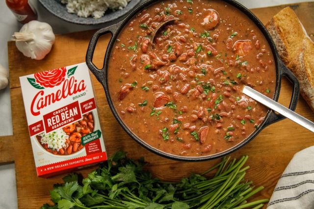 Stovetop Creole Red Beans next to a box of camellia brand red bean seasoning