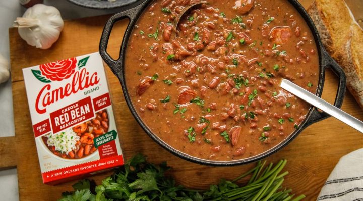 Stovetop Creole Red Beans next to a box of camellia brand red bean seasoning