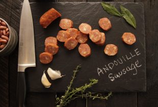 Andouille Sausage on Black Cutting Board