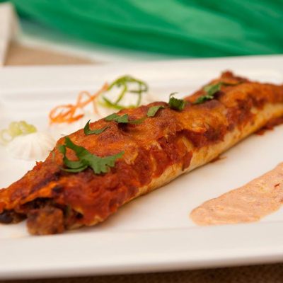 a plate of one Black Bean Seafood Enchiladas