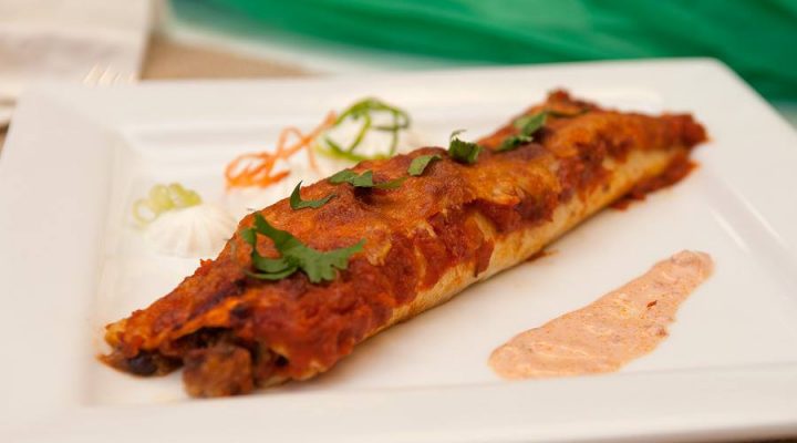 a plate of one Black Bean Seafood Enchiladas