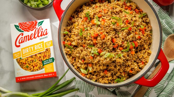 Gluten Free Cajun Dirty Rice in a red dutch oven next to a box of camellia brand dirty rice cajun seasoning mix