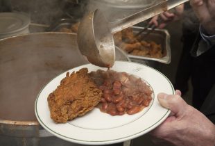 a chef at Galatoires Red Beans Supper close up of fried chicken