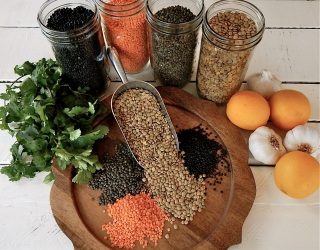 Various Types of Lentils Spill out on a cut board