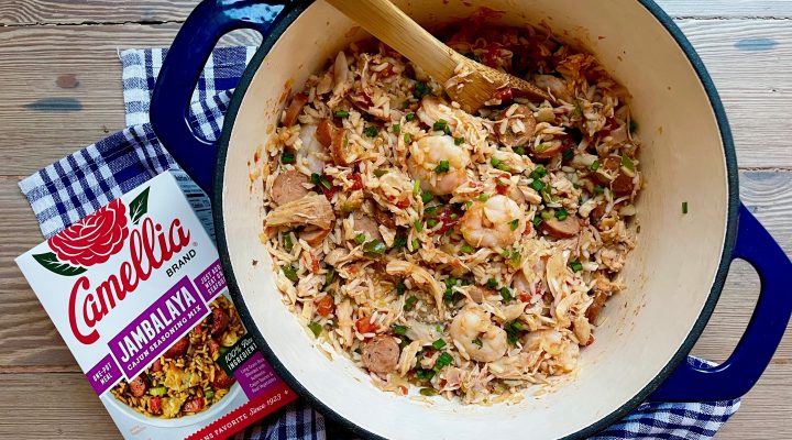 Blue dutch oven of Creole Jambalaya with Camellia Brand's Jambalaya Seasoning Mix next to it