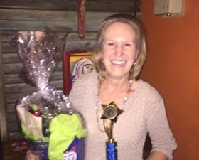 a chef posing with her winning trophy