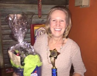 a chef posing with her winning trophy