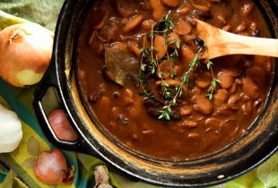 a dutch oven with baked vegetarian large lima beans