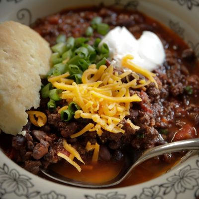 a plate of beef and black bean chili with a side of bread