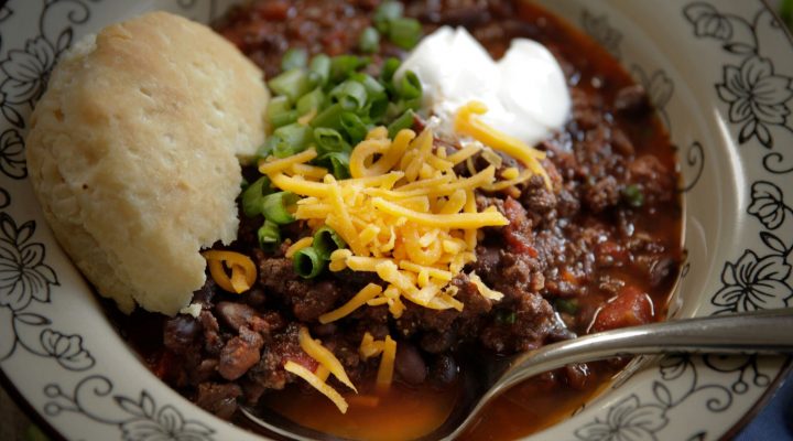 a plate of beef and black bean chili with a side of bread