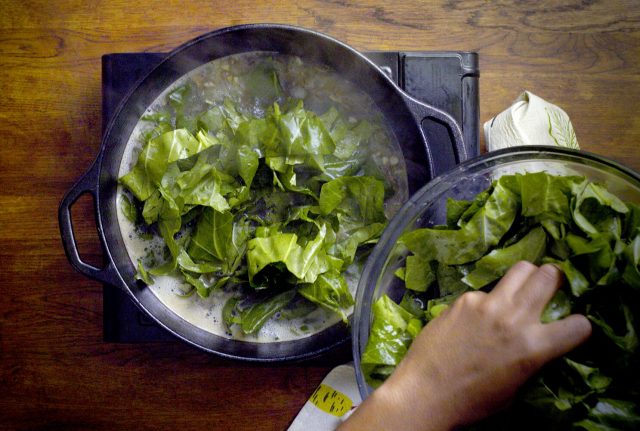 adding_collard_greens_to_pot