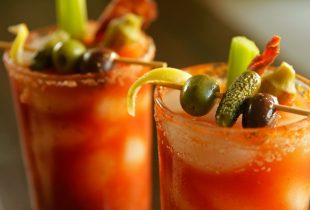 a close up of 2 smoky bloody marys