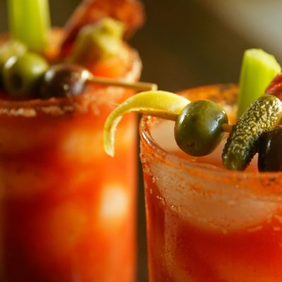 a close up of 2 smoky bloody marys