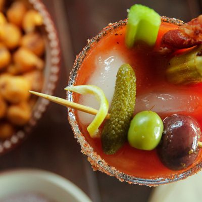 Smoky Bloody Mary next to a bowl of snacks