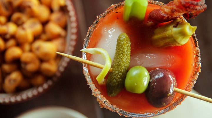 Smoky Bloody Mary next to a bowl of snacks