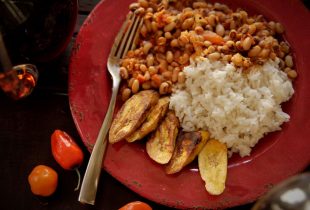 a plate of African red red with a side of rice and potato slices