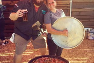 jay ducote cooking in a giant cast iron pot holding a glass of beer
