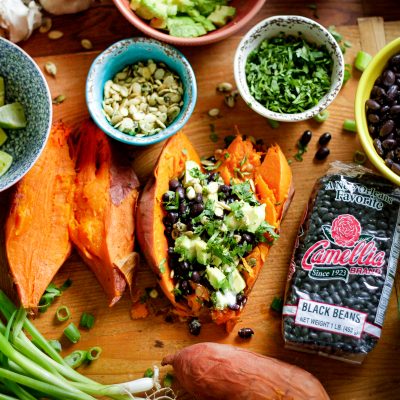 Black Bean Stuffed Sweet Potatoes featuring a bag of camellia brand black beans and various herbs and spices