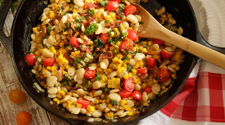 a cast iron pot full of southern summer succotash