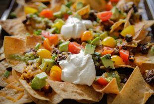 a close up of loaded nachos