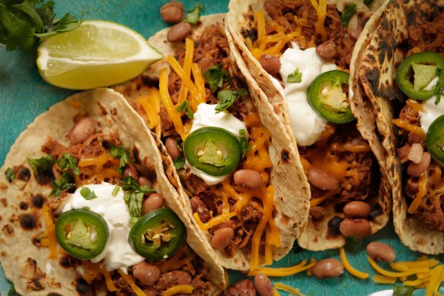 a close up of a plate of pork pinto tacos