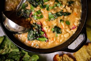 a dutch oven full of beans and greens soup