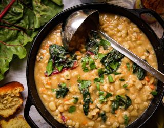 a dutch oven full of beans and greens soup