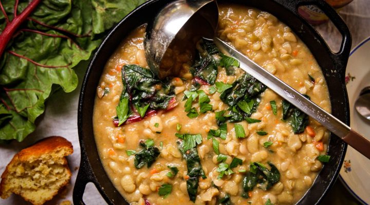 a dutch oven full of beans and greens soup
