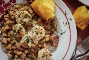 Garlicky Shrimp & Blackeye Peas with a side of corn bread on a plate