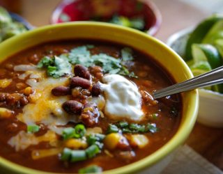 a close up of a bowl of slow cooker lentil black bean taco soup