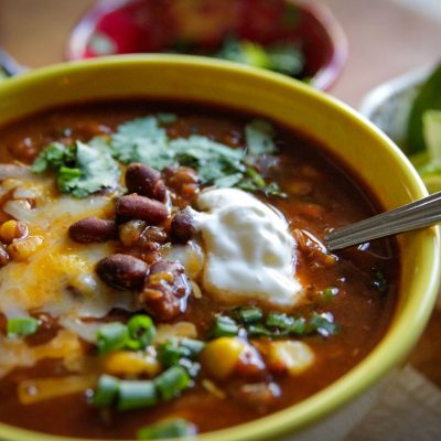 a close up of a bowl of slow cooker lentil black bean taco soup