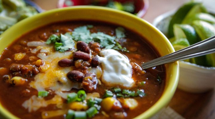a close up of a bowl of slow cooker lentil black bean taco soup