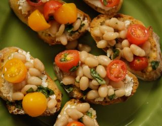 a close up of tomato white bean bruschetta