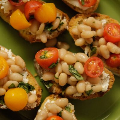 a close up of tomato white bean bruschetta