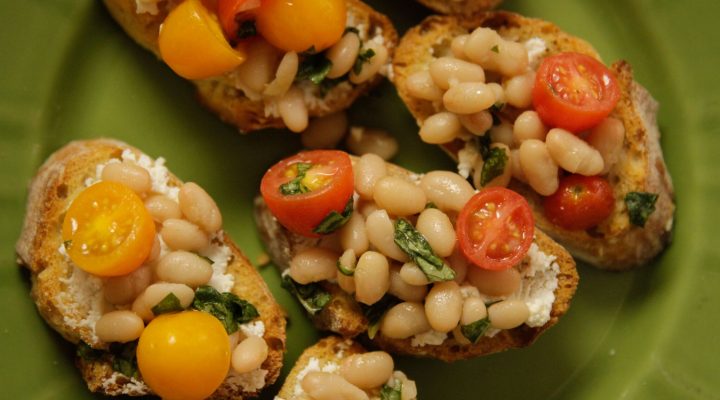 a close up of tomato white bean bruschetta