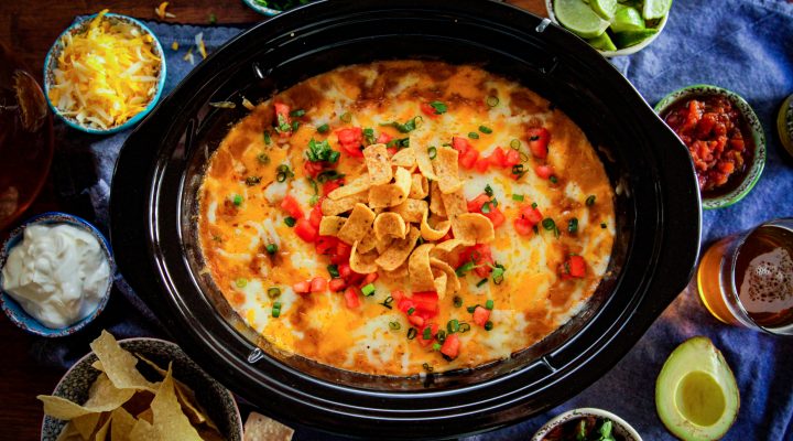 game day camellia bean dip in a crock pot featuring corn chips