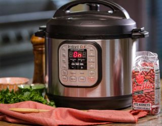 an Instant Pot of  New Orleans-Style Red Beans next to a package of red beans