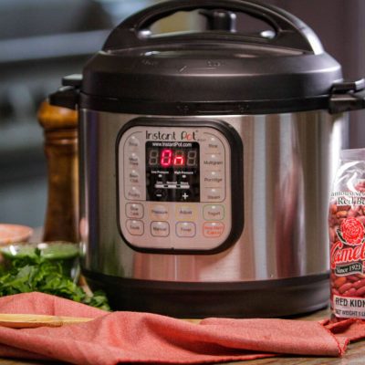 an Instant Pot of  New Orleans-Style Red Beans next to a package of red beans