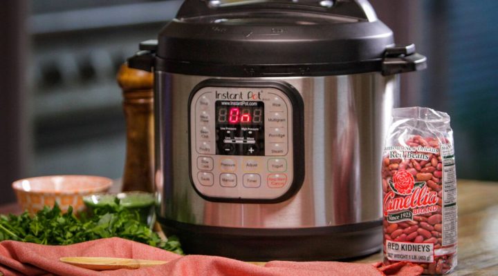 an Instant Pot of  New Orleans-Style Red Beans next to a package of red beans