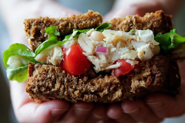 close up of white bean tuna sandwich with tomatoes