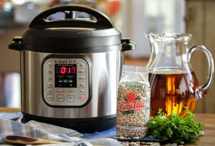 an instant pot next to a package of white beans